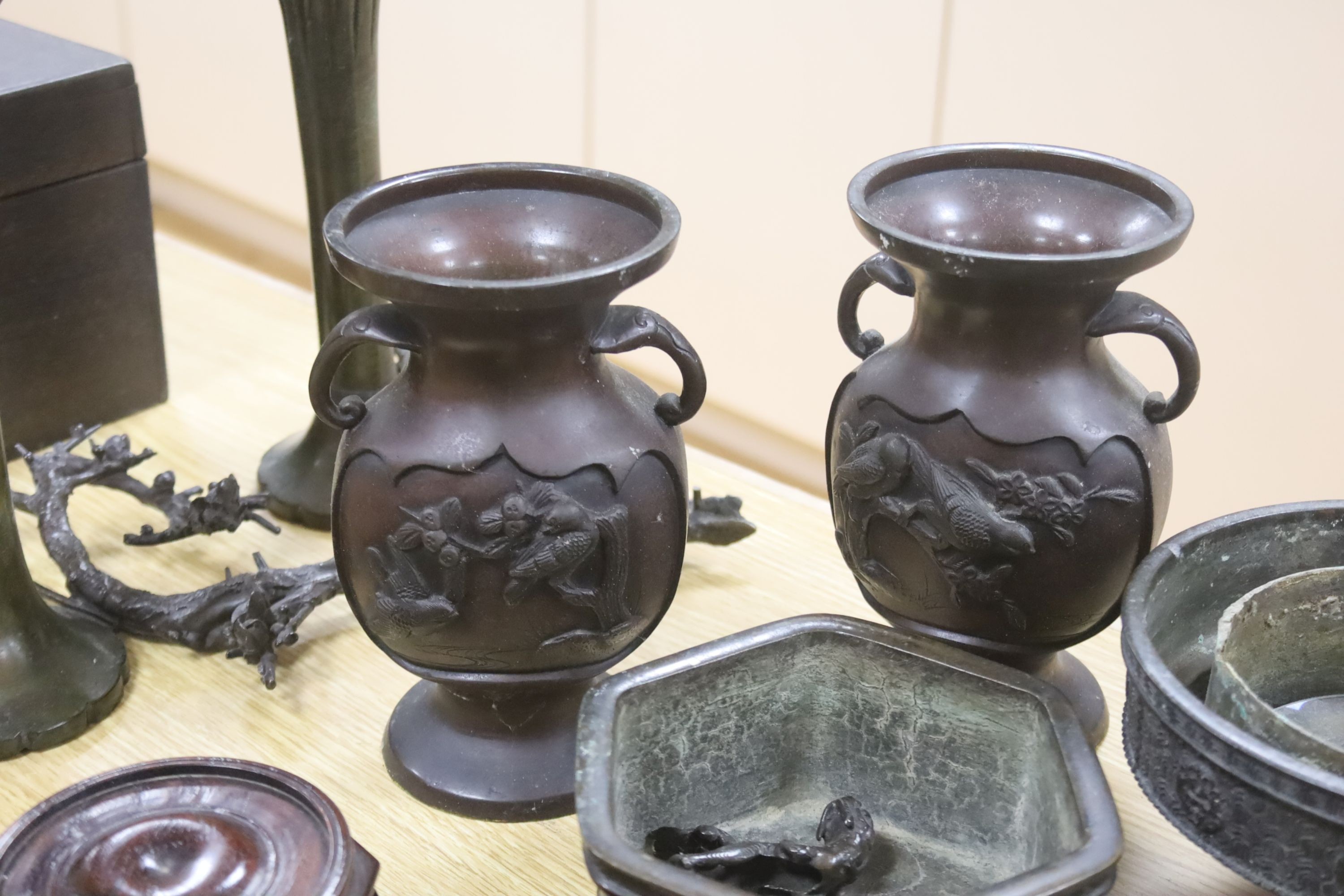 A group of Japanese bronze vases and sundry hardwood stands